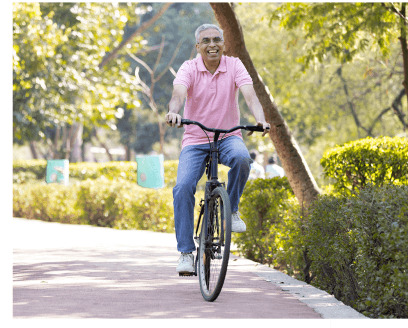 Male patient riding bike after seeing a Knee Osteoarthritis Doctor in Los Angeles
